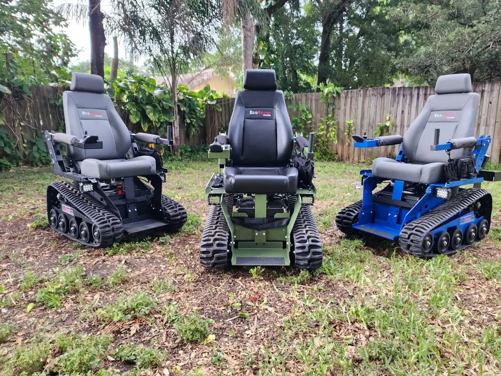 Three EcoRovers in different colors — black, green, and blue — parked on grass.